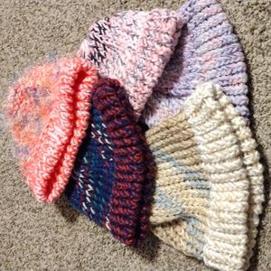 Five knitted kid size hats